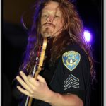 Bassist Jack Gibson Wearing Oakland Police Shirt