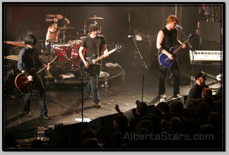 Troy Van Leeuwen, Joey Castillo, Michael Shuman and Josh Homme